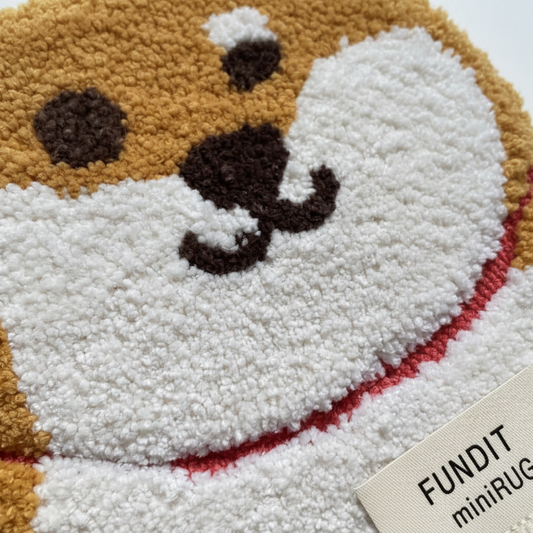 Close-up of tan Shiba Inu mini rug tufted texture showing golden-tan white and red collar detail on white background