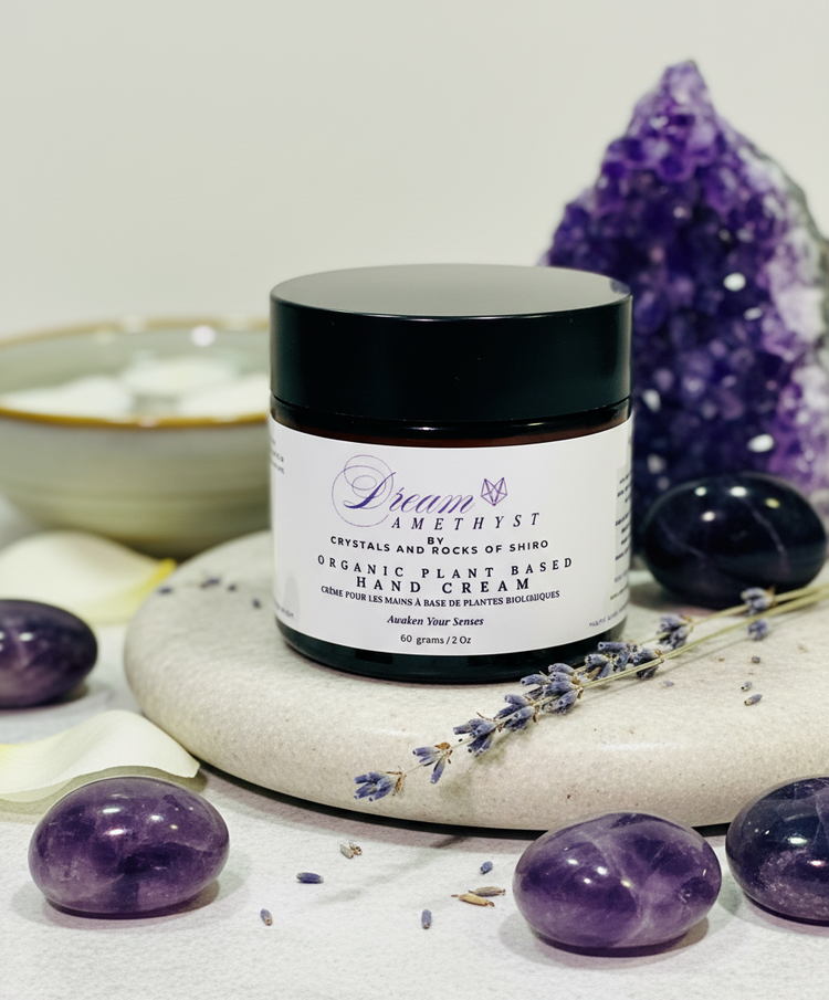 Dream Amethyst plant-based hand cream styled with raw amethyst crystals in soft purple lighting.